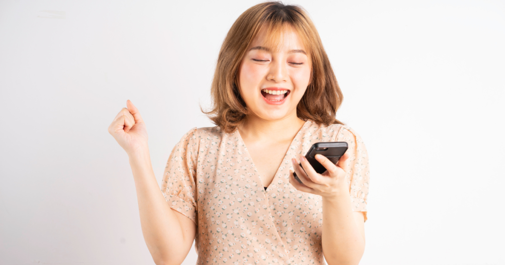 A happy woman using her cellphone availing quick cash loans