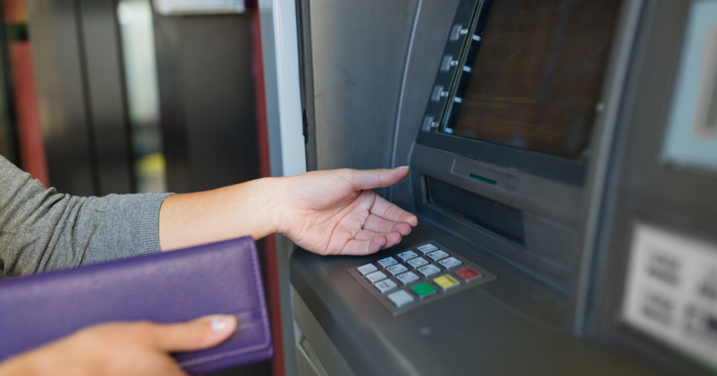 Withdrawing money in the ATM courtesy of the Security Bank Personal Loan