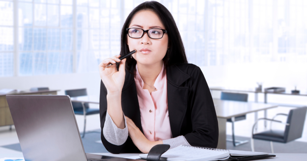 A woman thinking deeply about applying for a CIMB Bank Personal Loan